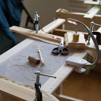 A white WonderFlex light on an embroidery frame.