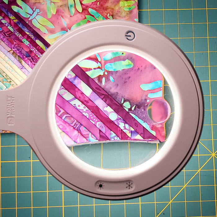 The power button and color-temperature buttons on our magnifier lamp head.