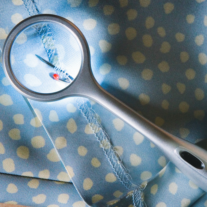 The Lighted Seam Ripper in use to rip out a seam.